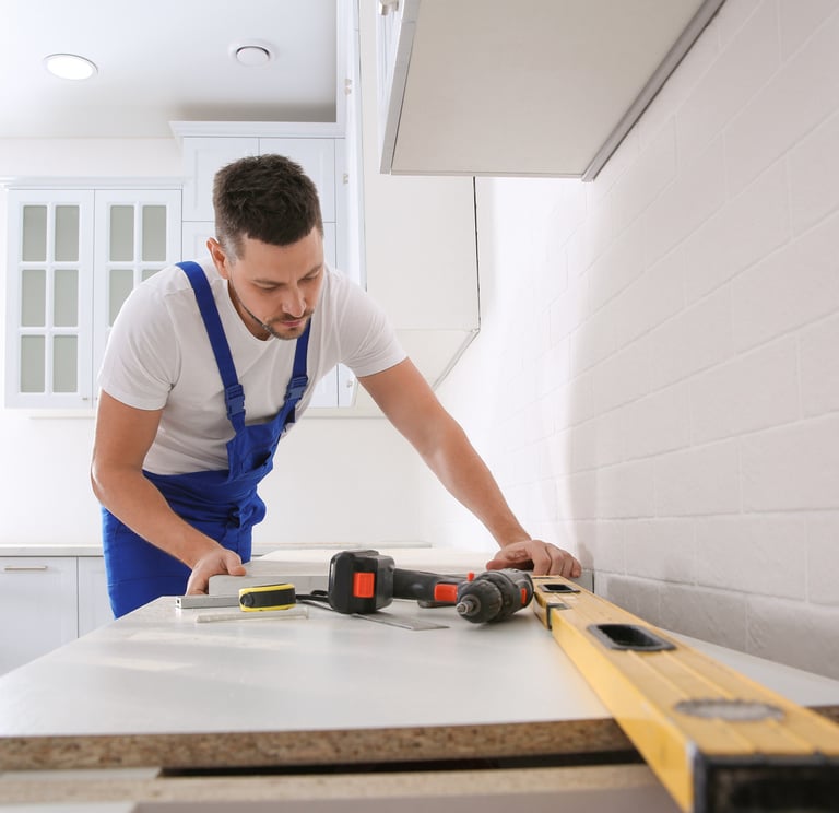 man using tools to measure a counter