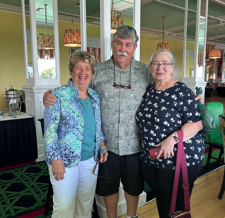 A picture of 2 women and a man in the middle.