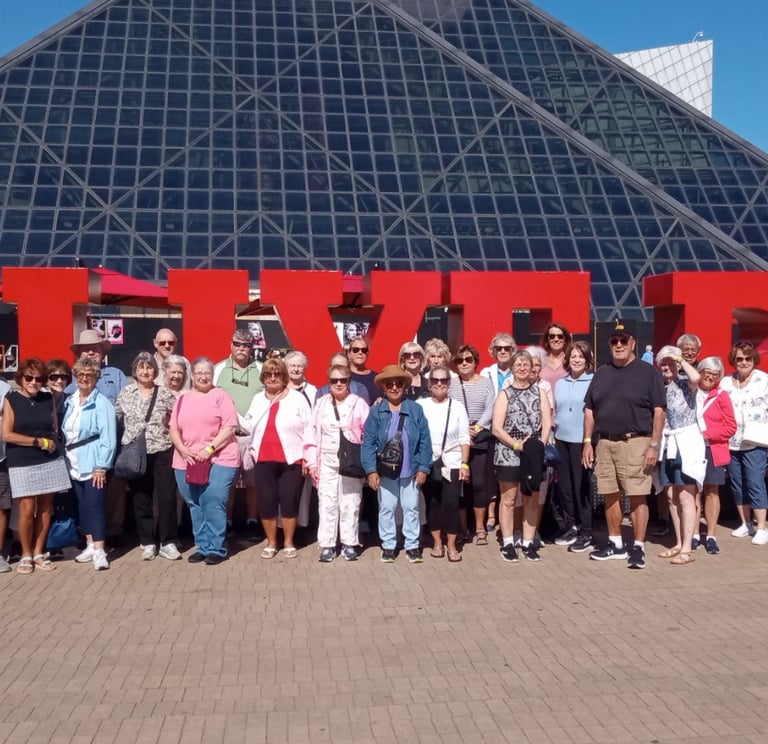 A picture of people standing in front of the Cleveland Rock and Roll hall of fame.