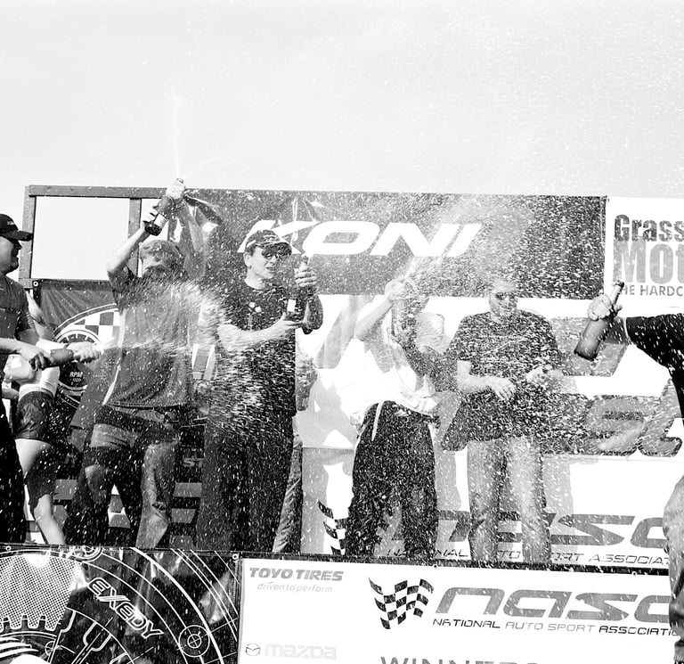Jason Friday pops champagne on podium