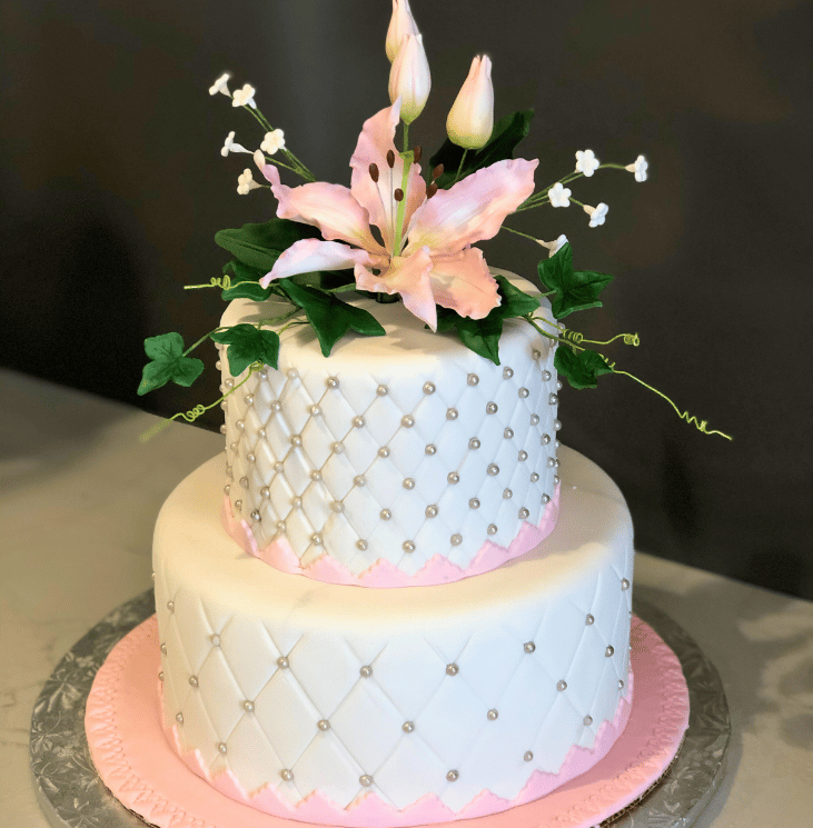Elegant celebration cake decorated with refined details, available in chocolate or vanilla perfect for birthdays, weddings