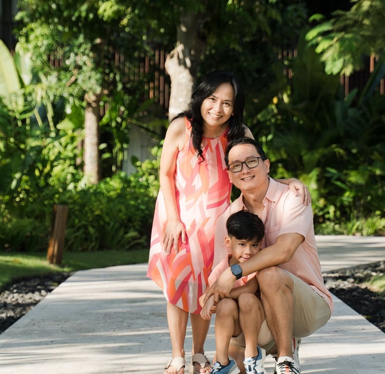 Mother father and child portrait on garden pathway at The Meru Sanur Bali family photography session