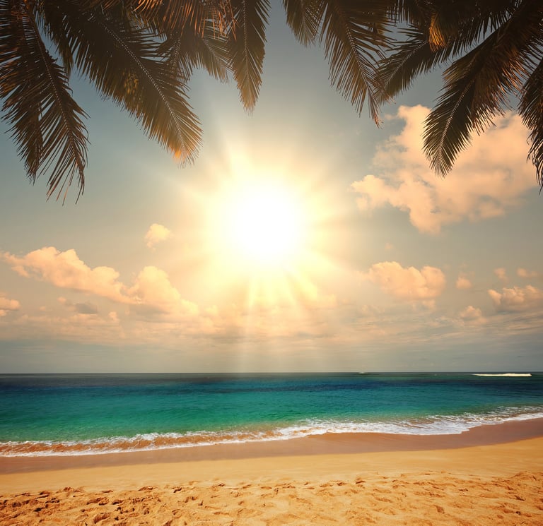 a beach scene with a sun shining over the ocean