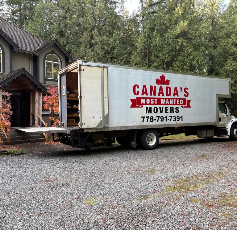 Canada’s Most Wanted Movers truck parked at a forest-side home in the Lower Mainland during a residential move.