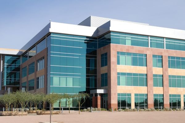 Large, four story office building with a lot of glass windows