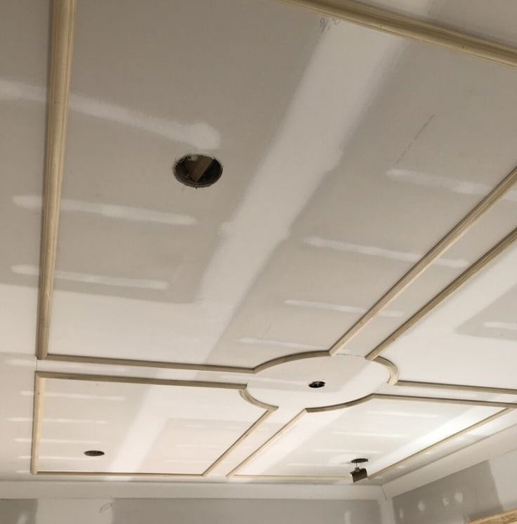 a ceiling with a ceiling fan and a ceiling fan