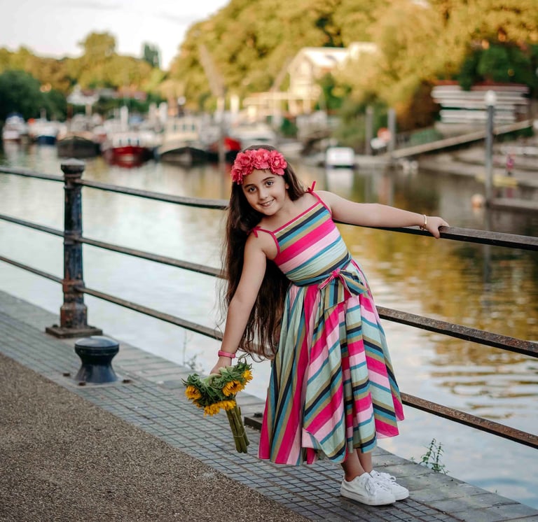 Girl holding flowers by riverside – Fred Art Studio kids photography