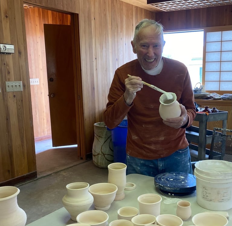 Rich Sim glazing his vase in an art therapy workshop