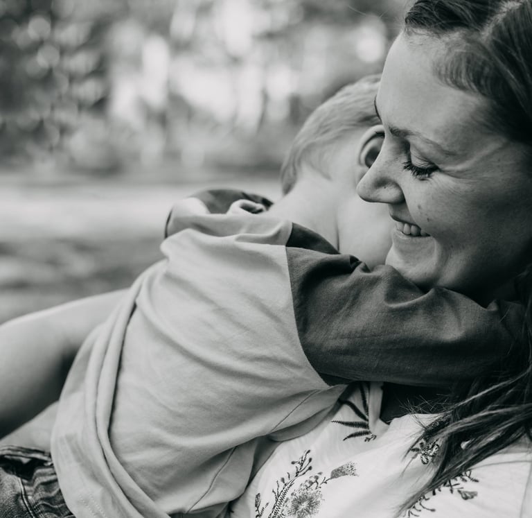 a woman holding a child in her arms