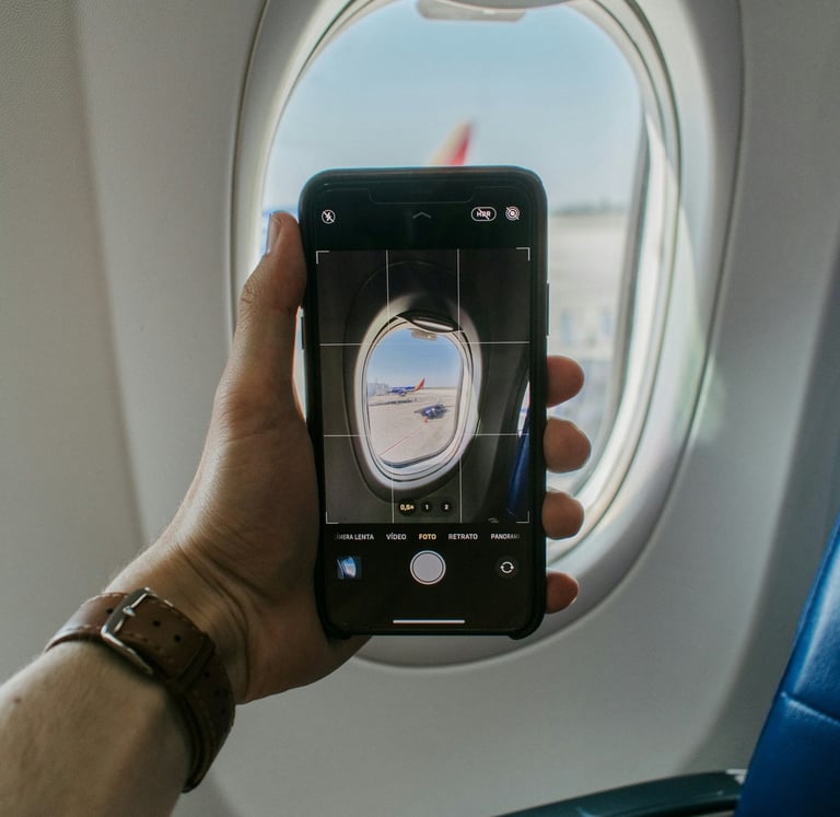 A person taking a photo in airplane