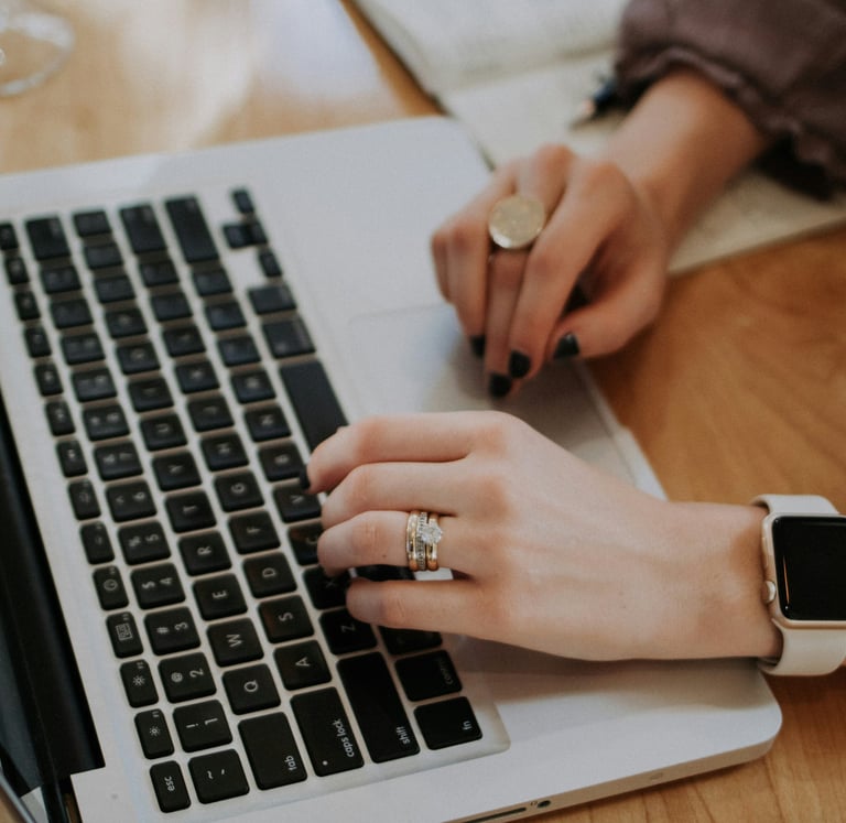 a woman's hands on a laptop computer