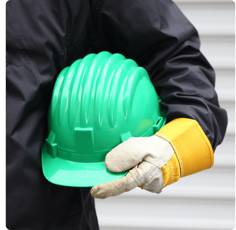 Técnico ou engenheiro de segurança do trabalho segurando capacete.