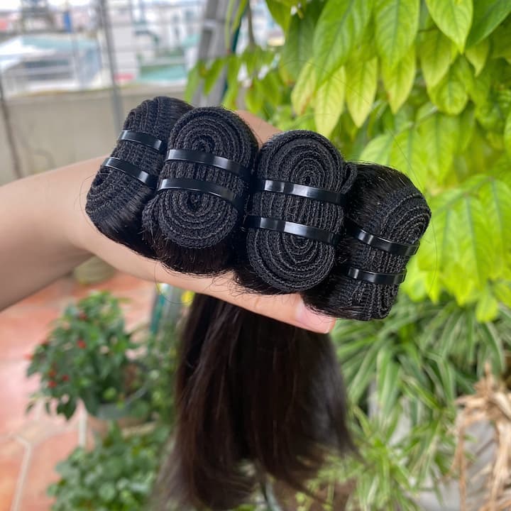 Close-up of machine weft bone straight Vietnamese hair with strong stitching