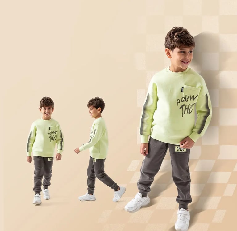 Young boy modeling MAB Kids Wear neon green sweatshirt and grey joggers outfit.