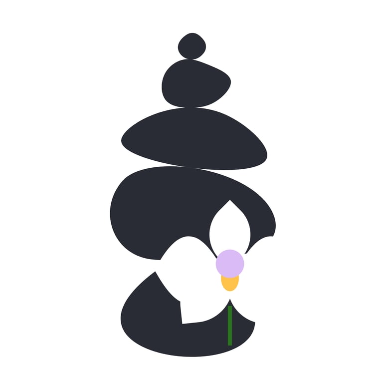 A black rock cairn with a white orchid which has a lavender & tangerine center