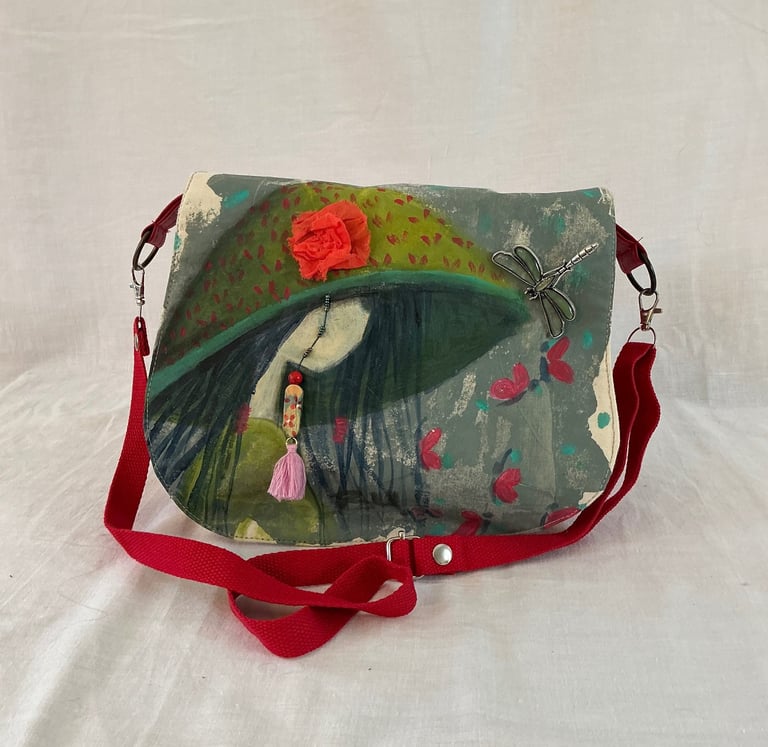 Hand-painted artistic crossbody bag featuring a girl in a hat with 3D floral and dragonfly accents.