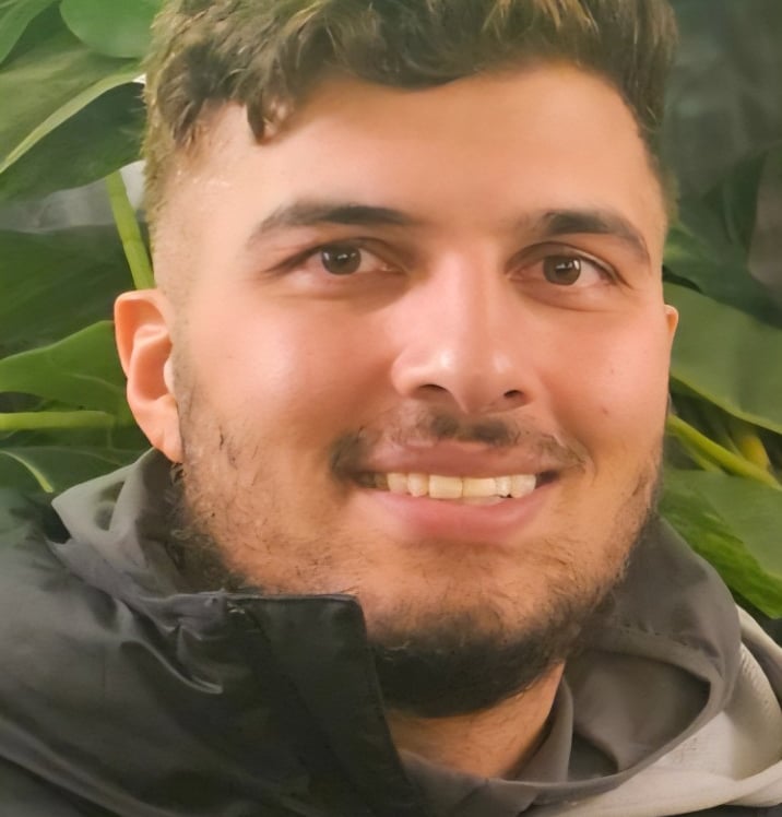 a man with a green umbrella in a green field