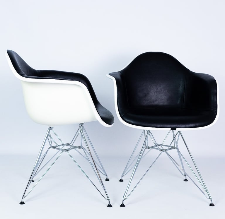 White and black plastic Eames chairs with metal legs – modern designer chairs