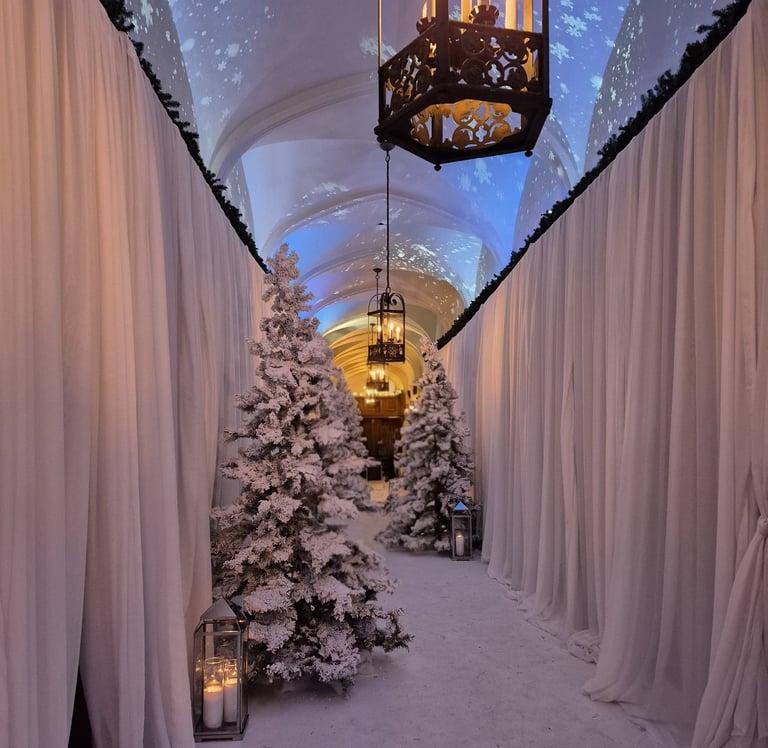 fir tree with fake snow and candles in hallway of castle
