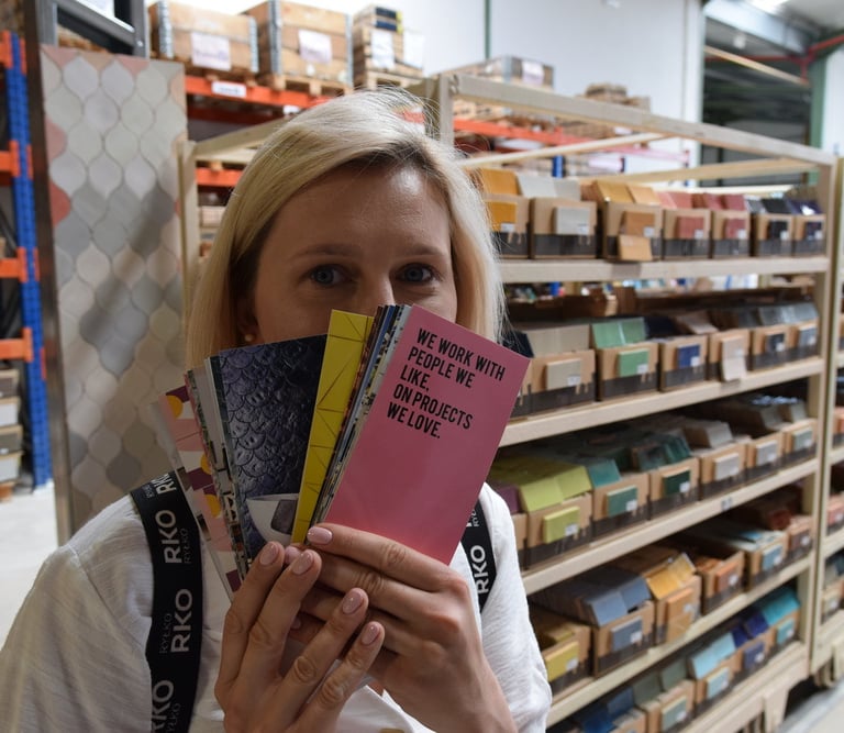 a woman holding a book in a store