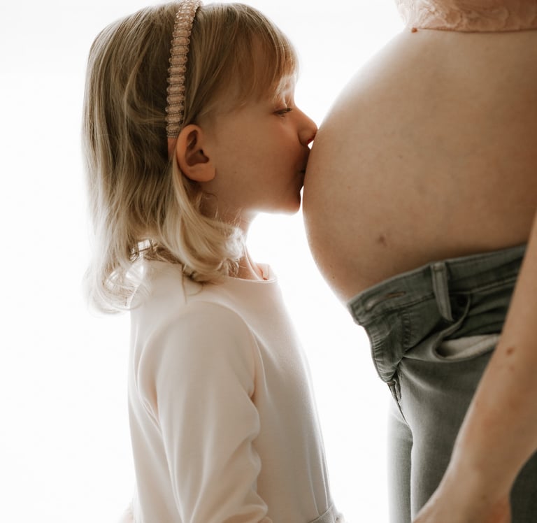 toddler kissing her mum's pregnant belly in studio - Littlehampton, Adelaide Hills