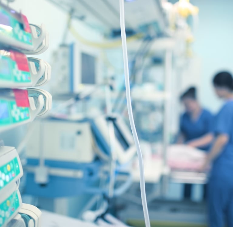 ICU nurses in Saudi hospital critical care unit with advanced monitoring equipment.