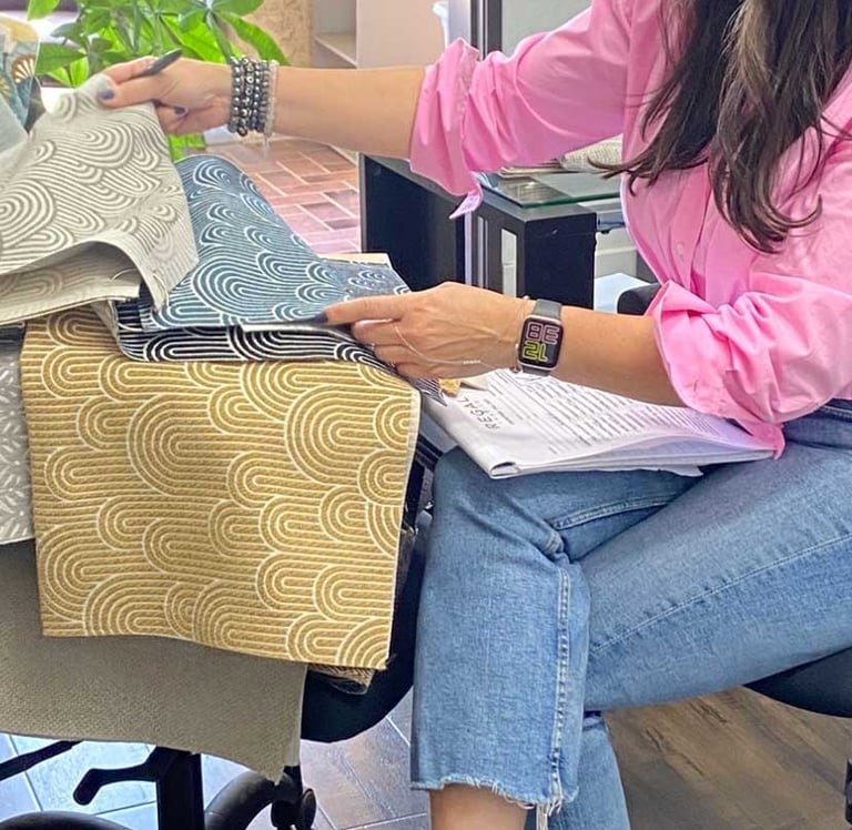 Sigal, founder of Solo Home Decor, selects fabrics while designing custom furniture.