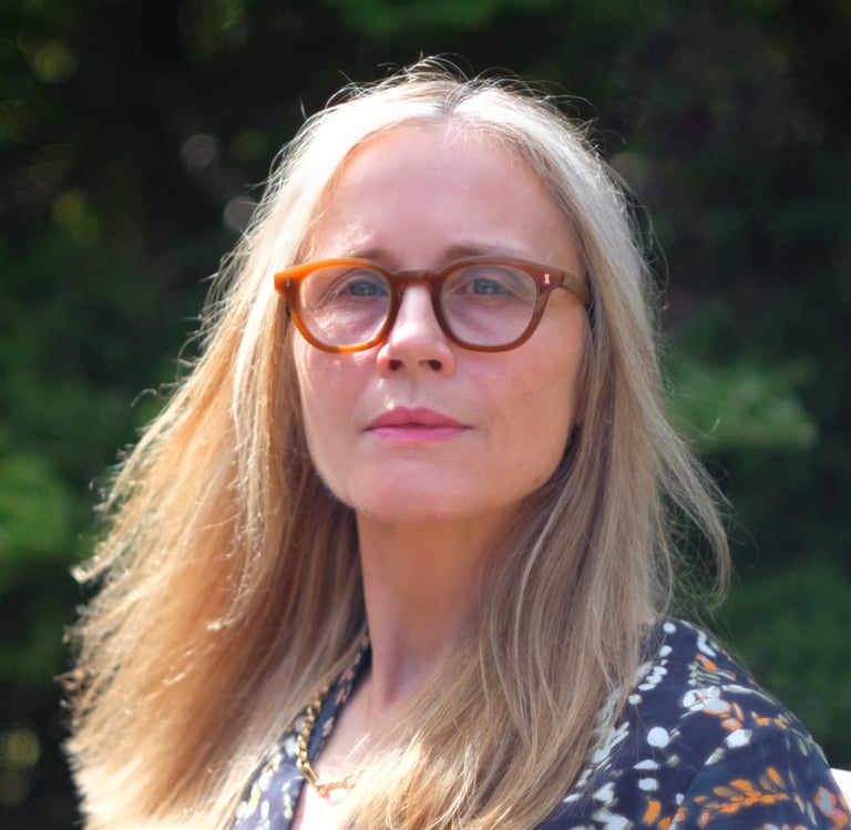 a woman with glasses and a blue dress