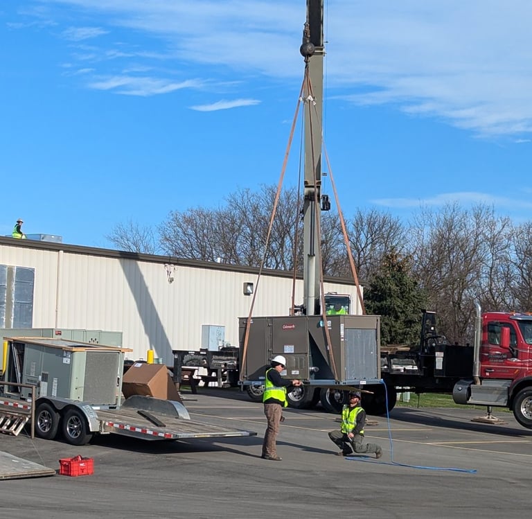 Commercial roof top unit being lifted by a crane by our TRAG HVAC team. No job too big or too small.
