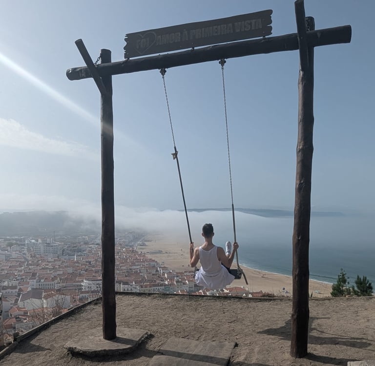 a man sitting on a swing set in a swing