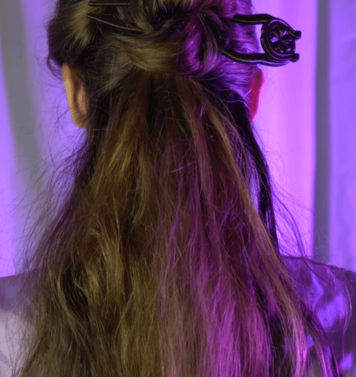 a woman with long hair and a hair comb