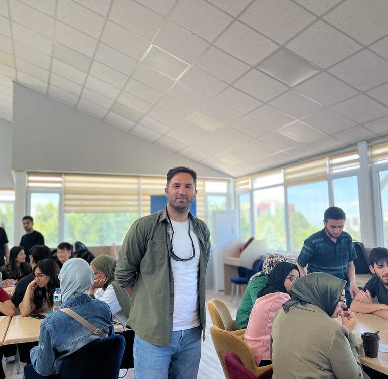 a man standing in a room with a bunch of people
