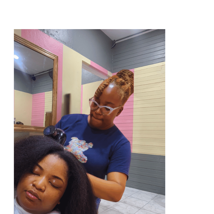 Hairstylist expertly working on a customer's natural hair at Kwik Fingaz Beauty Salon in Montego Bay.