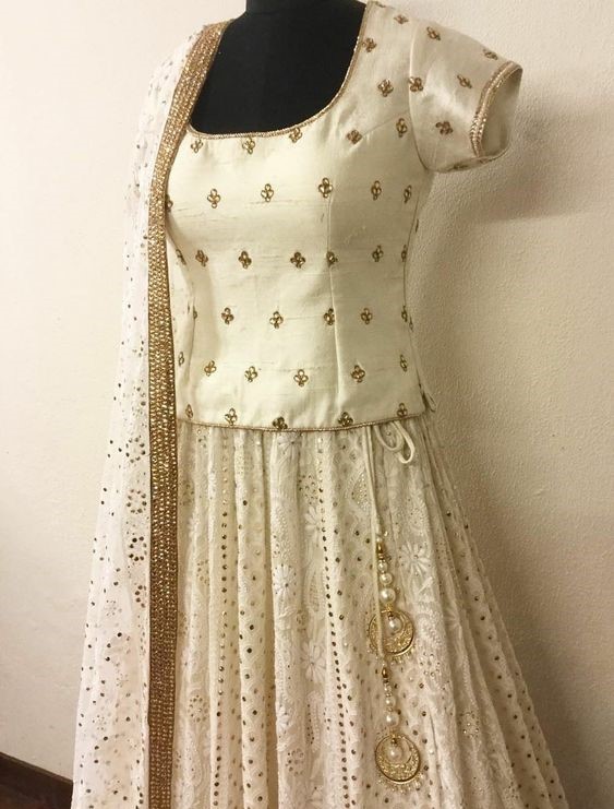 a white and gold colored dress with a white and gold dress