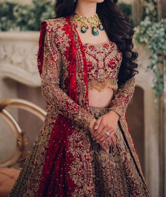 a bride in a red and gold bridalle wedding dress