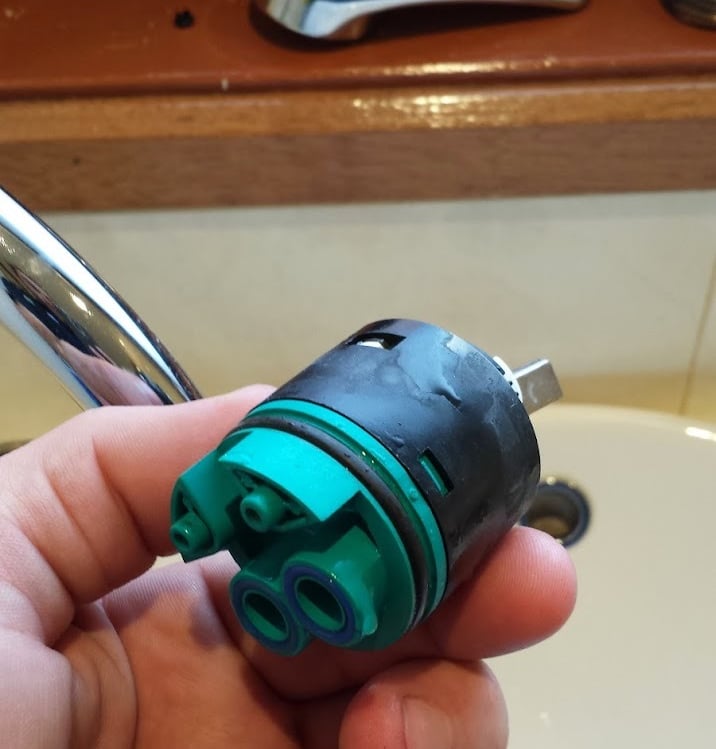 Old mixer cartridge about to be replaced