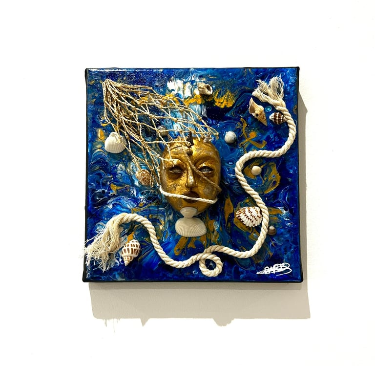 a blue and white tile with a face on it