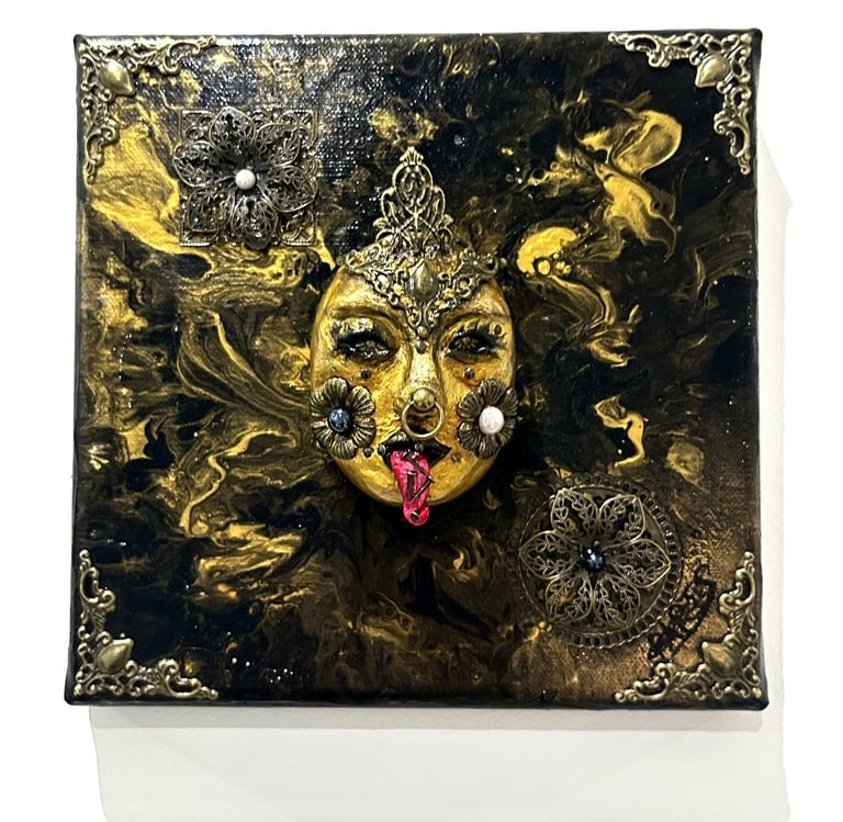 a painting of a woman's face with a gold face