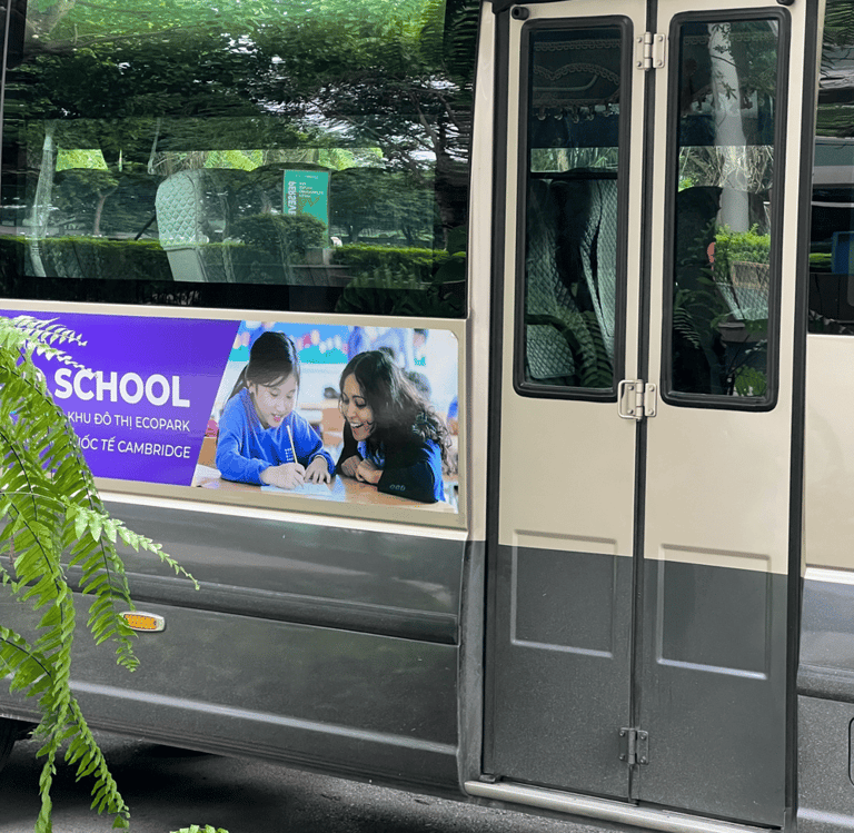 A bus with a advertisement of a school. The advertisement has a female teacher teaching students.