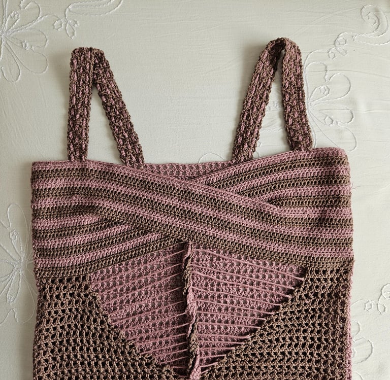 Handmade brown and pink crochet crop top with a cross-over front design and mesh stitch details.