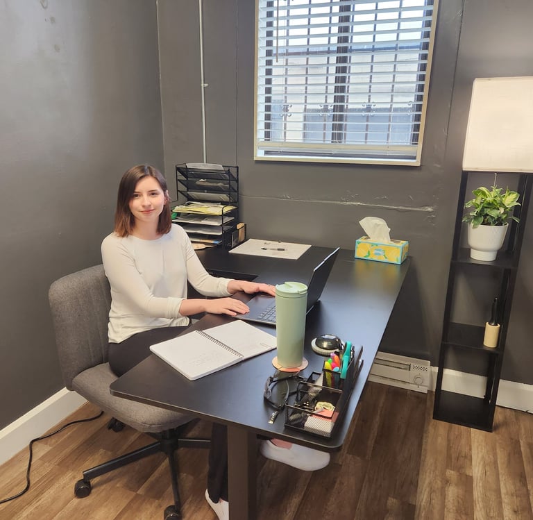 woman sitting at office desk smiling