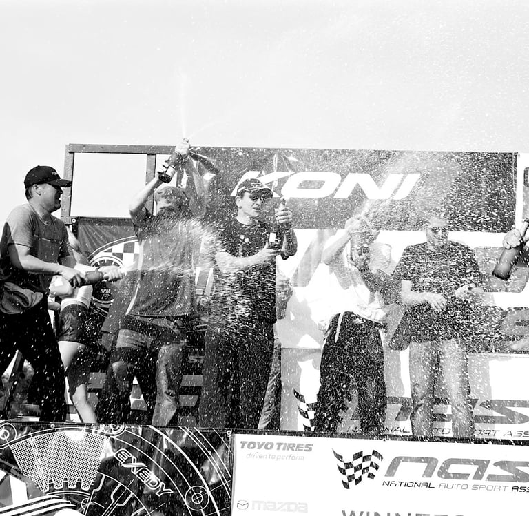 Jason Friday pops champagne on podium