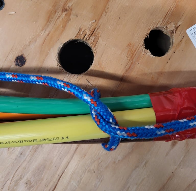 Close-up of multiple colored electrical conductors bundled together for a wire pull.