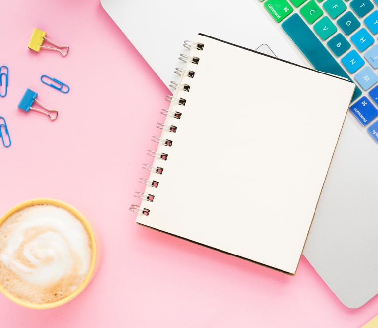 Creative workspace with laptop and notebook for brand strategy and marketing planning