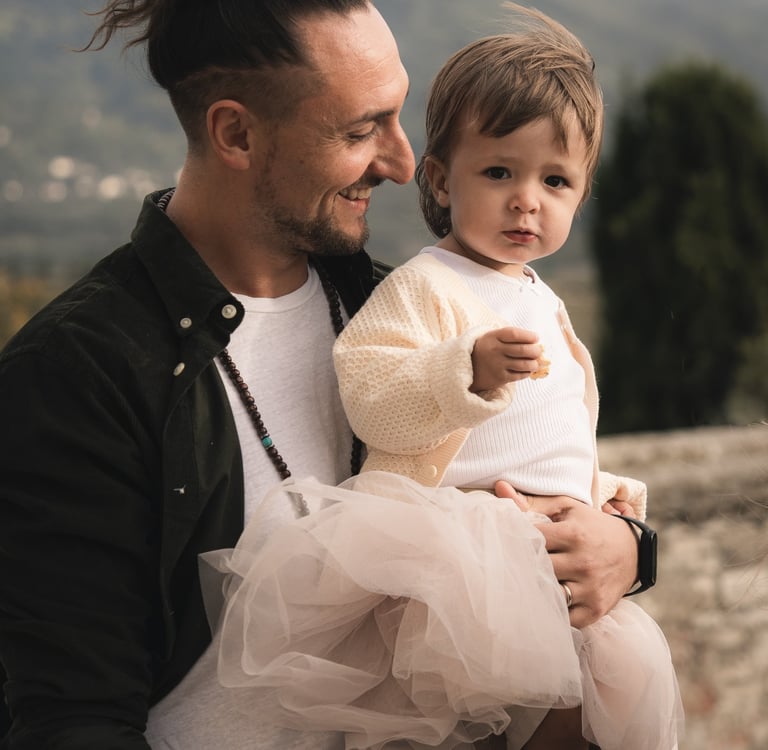 a man with a child on his lap, holding a baby