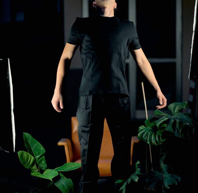 a man in a black shirt and white sneakers
