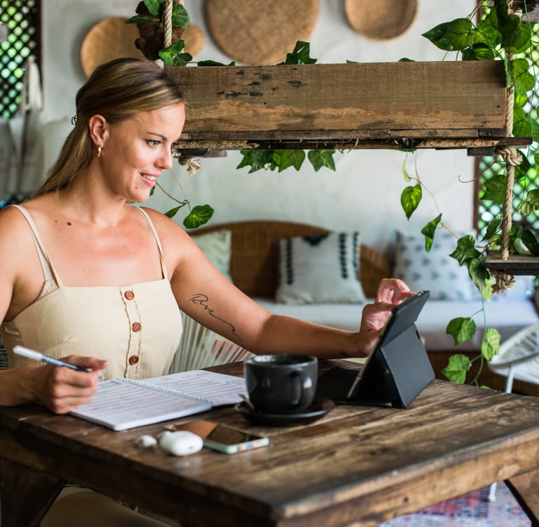 Woman working in a videocall boho living room with an ipad