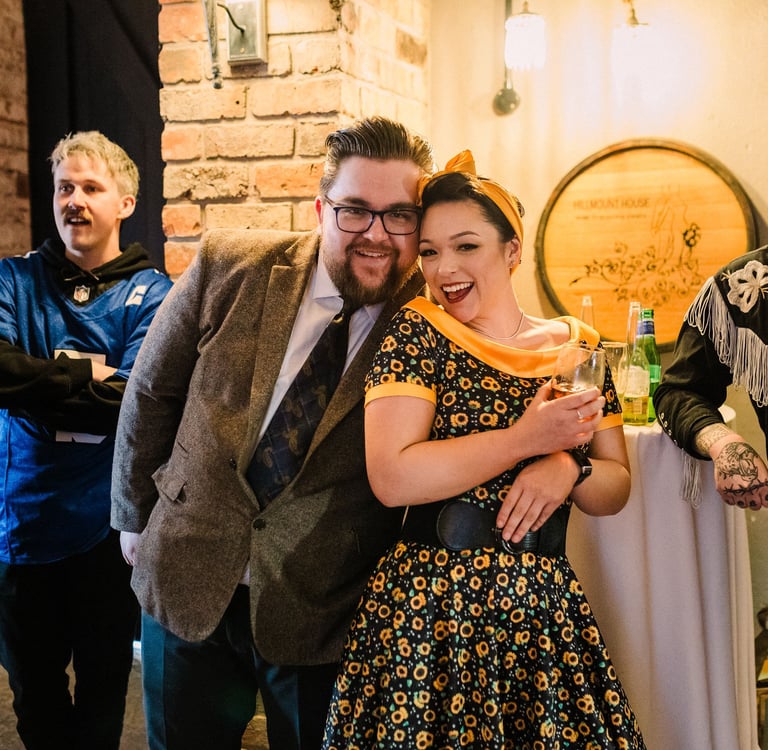 Man and woman smiling at 1950s murder mystery. stag party.