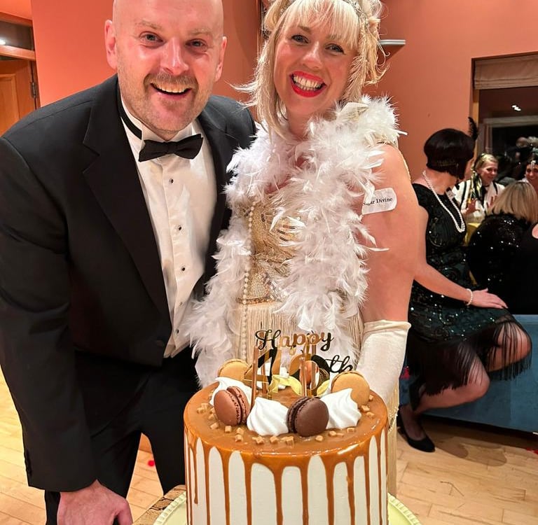 man and woman smiling at murder mystery birthday party