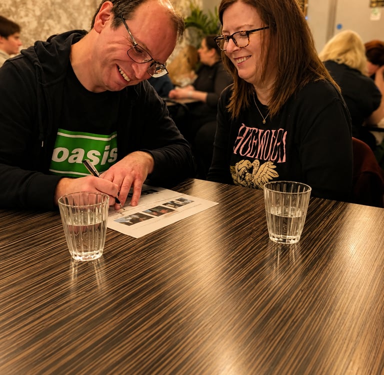 a man and a woman enjoy themselves at a quiz.